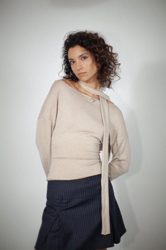 "ARAH Sweater: Jersey blend with a subtle shine. Boat neckline, optional scarf. Elevate your style with this chic, versatile piece."